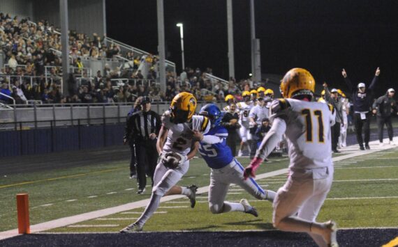 Forks coach Trevor Highfield signaled TD and he was correct as Spartan Noah Foster pulled in a Forks pass for the touchdown in front of a large crowd at Spartan Stadium putting Forks ahead 14 to 13 at the half against the Adna Pirates. Also in the photo is Spartan Cash Barajas (11). Photo by Lonnie Archibald