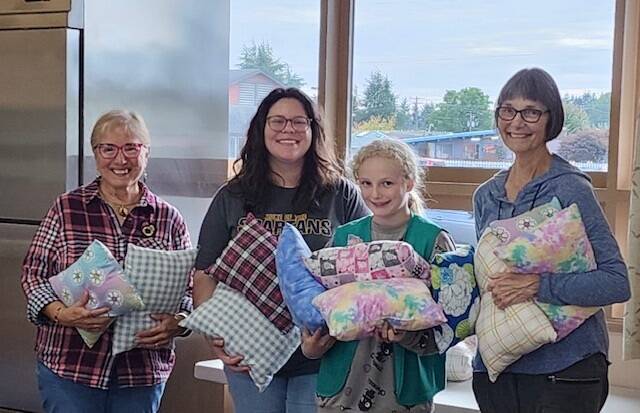 Girl Scout Troop 41844 presented pillows to Soroptimist International of the Olympic Rain Forest at their October meeting. The Girl Scouts made the pillows at Ginger’s Closet sewing room. They will be part of the comfort kits SIORF assembles and donates to children in emergency foster placement.
Pictured: Sharla Fraker, SIORF, Alyssa Brickey, GS leader, Mackenzie Brickey, GS, and Cindy Mesenbrink, SIORF. Submitted photo