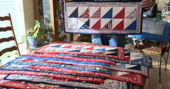 Piecemakers Club member, Martha Paul, donated 20 American Heroes table runners to Forks American Legion Post 106 Commander Bubba Bolin. These patriotic table runners will be gifted to veterans. Bubba, seen here in this photo, shared, “It is an honor to have received those table runners and I will hand them out next week at our Coffee with Comrades on Thursday morning.” Submitted photo