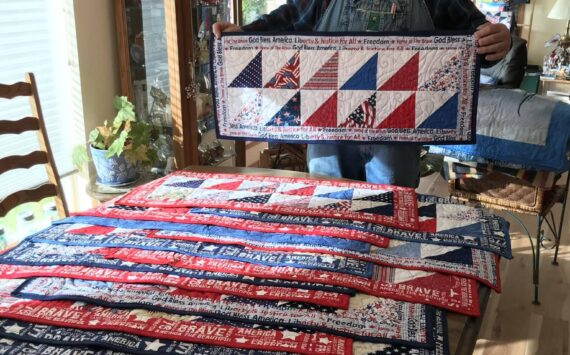 Piecemakers Club member, Martha Paul, donated 20 American Heroes table runners to Forks American Legion Post 106 Commander Bubba Bolin. These patriotic table runners will be gifted to veterans. Bubba, seen here in this photo, shared, “It is an honor to have received those table runners and I will hand them out next week at our Coffee with Comrades on Thursday morning.” Submitted photo