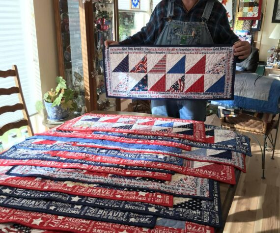 <p>Piecemakers Club member, Martha Paul, donated 20 American Heroes table runners to Forks American Legion Post 106 Commander Bubba Bolin. These patriotic table runners will be gifted to veterans. Bubba, seen here in this photo, shared, “It is an honor to have received those table runners and I will hand them out next week at our Coffee with Comrades on Thursday morning.” Submitted photo</p>