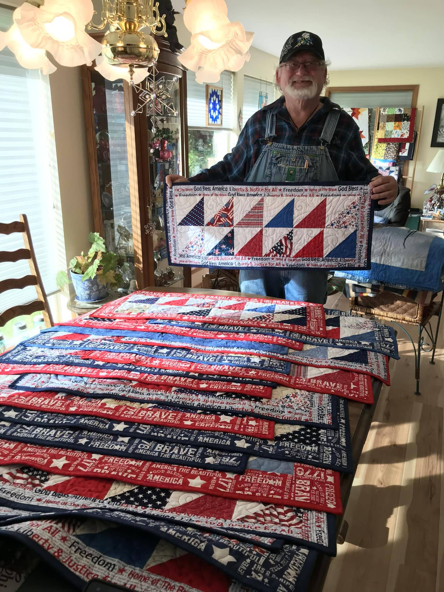 Piecemakers Club member, Martha Paul, donated 20 American Heroes table runners to Forks American Legion Post 106 Commander Bubba Bolin. These patriotic table runners will be gifted to veterans. Bubba, seen here in this photo, shared, “It is an honor to have received those table runners and I will hand them out next week at our Coffee with Comrades on Thursday morning.” Submitted photo