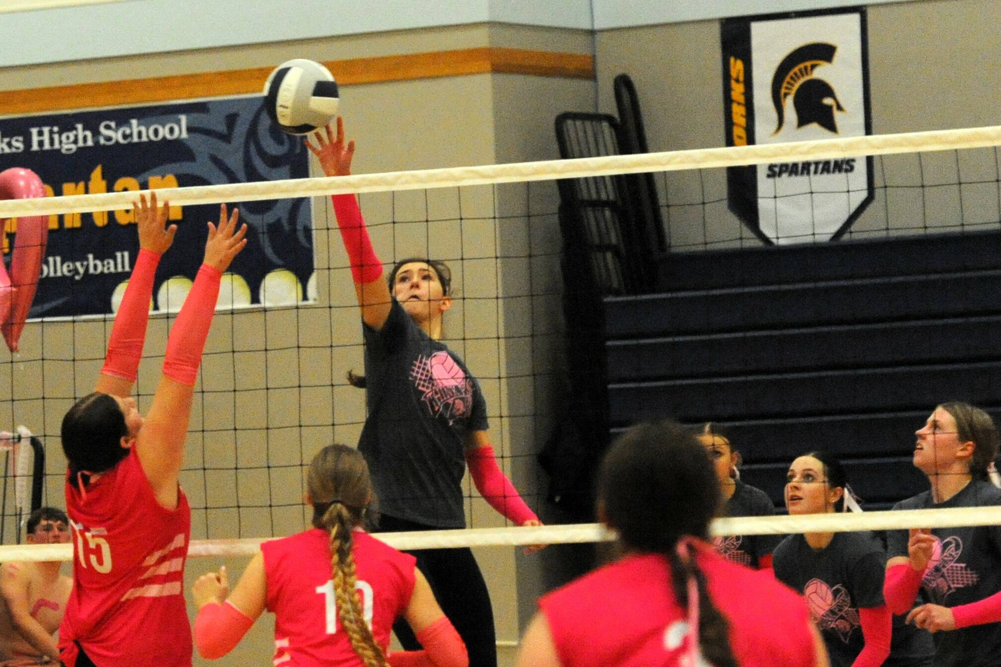 Spartan Erika Williams hits against Ilwaco who Forks defeated 3 to 0 on this “Cancer Awareness” evening held in the Spartan Gym. Also in the action are Chloe Gaydeski and Keana Rowley. Photo by Lonnie Archibald