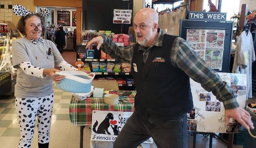 All Darren Sackett, from Forks Outfitters, needed was a drumroll as he struck a dramatic pose as he drew the winning ticket for the Friends of Forks Animals Halloween Basket. Betsy Cadwell, FOFA member, is assisting. The lucky winner was Mary Ulin!
The basket and contents were donated by FOFA members Karen Clark and Deb Pavlich Boaz.
Thanks to everyone who bought tickets!! Submitted photo