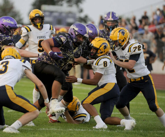 Michael Dashiell/Olympic Peninsula News Group Sequim’s Lars Wiker, with ball, is tackled by, from left, Forks’ Gage Willenbrink, Bubba Hernandez and Sawyer Graham. Hernandez, Graham and Willenbrink were all honored in all-league voting by Class 2B Central League West Division coaches.