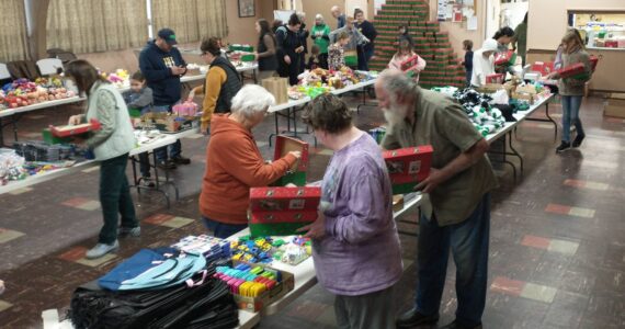 Good Samaritan Foundation representatives and local volunteers gathered at the Congregational Church fellowship hall, filling 475 shoeboxes for the Operation Christmas Child program. The team, which included Deborah and Marty Dillion with Don Lawley, completed their work in just two hours on Saturday morning. These shoeboxes, packed with care and Christmas joy, will bring smiles to children around the world. Photo Deborah Dillon