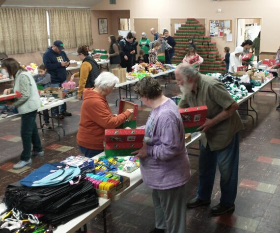 <p>Good Samaritan Foundation representatives and local volunteers gathered at the Congregational Church fellowship hall, filling 475 shoeboxes for the Operation Christmas Child program. The team, which included Deborah and Marty Dillion with Don Lawley, completed their work in just two hours on Saturday morning. These shoeboxes, packed with care and Christmas joy, will bring smiles to children around the world. Photo Deborah Dillon</p>