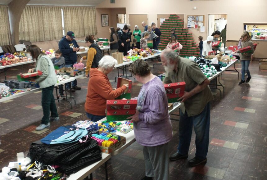 <p>Good Samaritan Foundation representatives and local volunteers gathered at the Congregational Church fellowship hall, filling 475 shoeboxes for the Operation Christmas Child program. The team, which included Deborah and Marty Dillion with Don Lawley, completed their work in just two hours on Saturday morning. These shoeboxes, packed with care and Christmas joy, will bring smiles to children around the world. Photo Deborah Dillon</p>