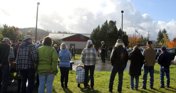 Dave Williams center of the photo offers a Veteran’s Day message to about 50 West End residents who gathered at the Gold Star Families Memorial Monument at the Forks Transit Center on Monday morning. Pastor Bob Schwartz, First Baptist Church, offered prayer, and Megan Rasmussen ended the ceremony with TAPS. It was raining up until 11 a.m. and then blue sky appeared (seen in the corner of the photo)! Williams, who is a weatherman….took credit for the break in the rain. Photo Christi Baron