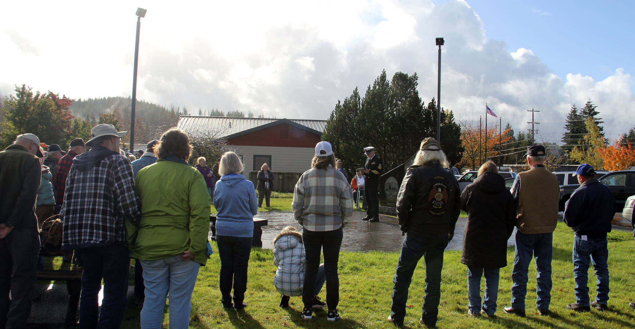 Dave Williams center of the photo offers a Veteran’s Day message to about 50 West End residents who gathered at the Gold Star Families Memorial Monument at the Forks Transit Center on Monday morning. Pastor Bob Schwartz, First Baptist Church, offered prayer, and Megan Rasmussen ended the ceremony with TAPS. It was raining up until 11 a.m. and then blue sky appeared (seen in the corner of the photo)! Williams, who is a weatherman….took credit for the break in the rain. Photo Christi Baron