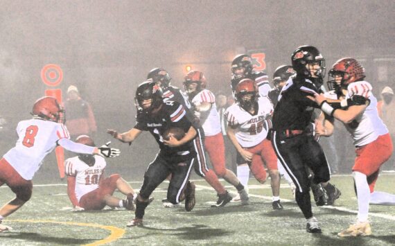 Red Devil Jodell Wimberly (1) makes his way through the fog and past Mule defenders en route to a touchdown Friday evening in Forks where Neah Bay defeated Wahkiakum 70 to 14 to advance in the 1B state playoffs. The Red Devils will face Almira Coulee Hartline on Saturday, November 23 at Lions Field in Moses Lake at 1 p.m. Photo by Lonnie Archibald