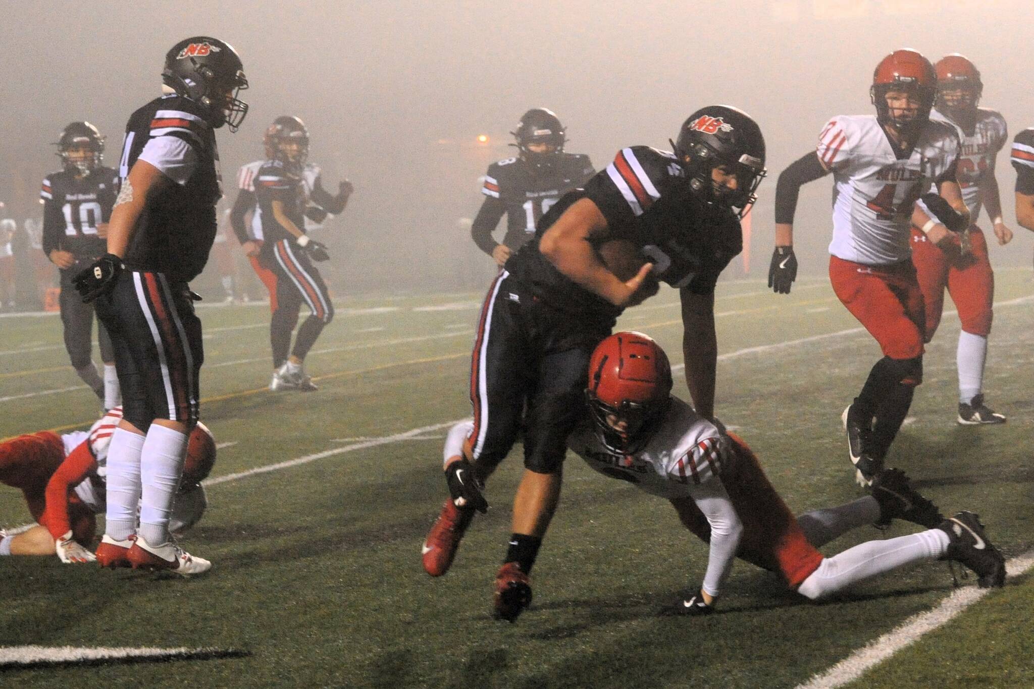 Red Devil Tyler Swan escaped the tackle of this Wahkiakum defender as Neah Bay defeated the Mules on the turf of Spartan Stadium to advance in the state 1B football playoffs. Photo by Lonnie Archibald