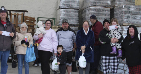 West End Business & Professional Association held its second Turkey Drawing of the season on Saturday outside Forks Outfitters. Winners of turkeys were Sarah Warner, Lori Christenson, and Nani Gomez. Winning Sully’s gift certificates were Christa Baker, Tony Porter, and Hailey Hayden; Cathy Harner won Sasquatch coffee products from the Sasquatch the Legend store. Remember to ask for blue tickets when you shop locally. Bring them to Outfitters on Saturdays for the 1 p.m. drawings. Nov. 23 will be the last of the Turkeys and then Santa Bucks will be awarded Nov. 30, Dec. 7, 14, and 21.
Also, remember to purchase your tickets for the WEBPA $500 shopping spree which will be drawn on Dec. 21. Winner need not be present for the Shopping Spree prize.
Happy winners pose here with their family members! Photo Christi Baron