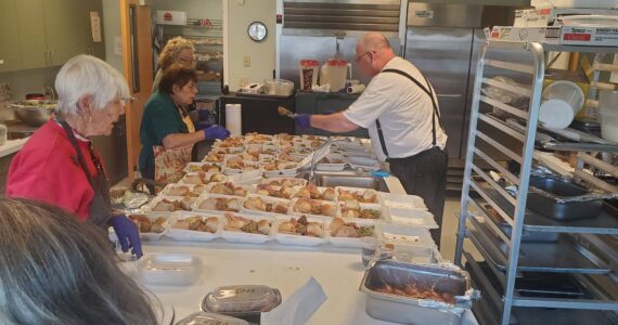 Feeding 5000 volunteers work to prepare the many meals that they served last Tuesday at the Community Center. Submitted photo