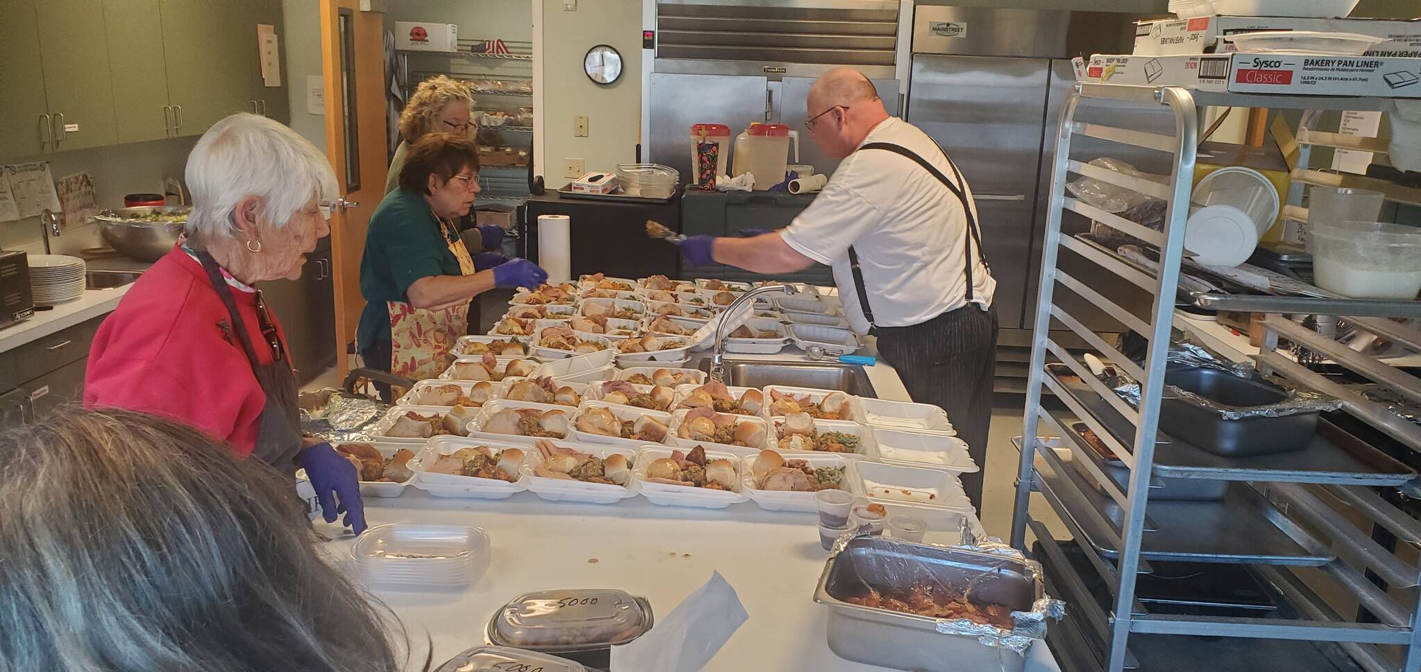 Feeding 5000 volunteers work to prepare the many meals that they served last Tuesday at the Community Center. Submitted photo