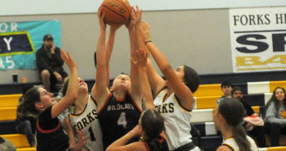 Spartans Bailey Johnson (1) and Pearl Salazar (5) compete with the Wildcats for ball control Saturday afternoon in the Spartan Gym where Forks defeated Crosspoint Christian 59 to 47. 
Photo by Lonnie Archibald