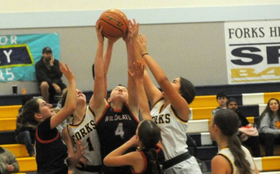 Spartans Bailey Johnson (1) and Pearl Salazar (5) compete with the Wildcats for ball control Saturday afternoon in the Spartan Gym where Forks defeated Crosspoint Christian 59 to 47. 
Photo by Lonnie Archibald