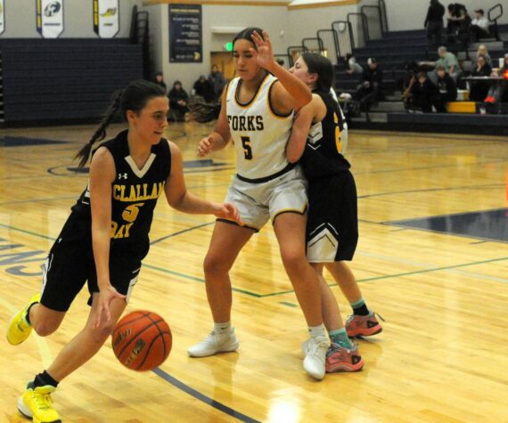 Photo by Lonnie Archibald
Bruin Kaleeka Mendoza McCarty drives around Spartan Peril Salazar while Bruin Helen Smathers sets a screen. Looking on is Spartan Kylie Hull (4). The Forks JV’s defeated Clallam Bay 37 to 23 prior to the Forks vs Ilwaco game January 6 in the Spartan Gym.