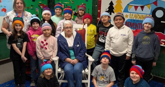 Submitted photo
Cathy Johnson (left) and her mother, Frances Blakely (center), join Forks Elementary School students as they proudly wear the hats they designed. The students, who are now 3rd graders in Mrs. Haag’s class, were recently invited to the FES library to see their creations brought to life and receive their handmade hats.