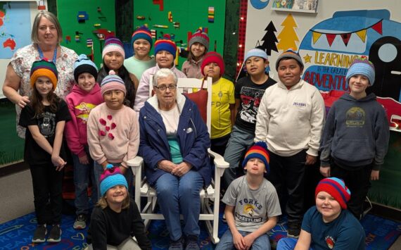 Submitted photo
Cathy Johnson (left) and her mother, Frances Blakely (center), join Forks Elementary School students as they proudly wear the hats they designed. The students, who are now 3rd graders in Mrs. Haag’s class, were recently invited to the FES library to see their creations brought to life and receive their handmade hats.