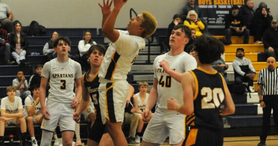 Photo by Lonnie Archibald
Spartan Carlos Soto puts up a shot against Ilwaco who Forks defeated 60 to 51 in JV action. Also in the contest are teammates Gage Willenbrink (3) and Radly Bennett (40).