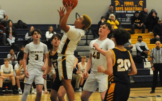 Photo by Lonnie Archibald
Spartan Carlos Soto puts up a shot against Ilwaco who Forks defeated 60 to 51 in JV action. Also in the contest are teammates Gage Willenbrink (3) and Radly Bennett (40).