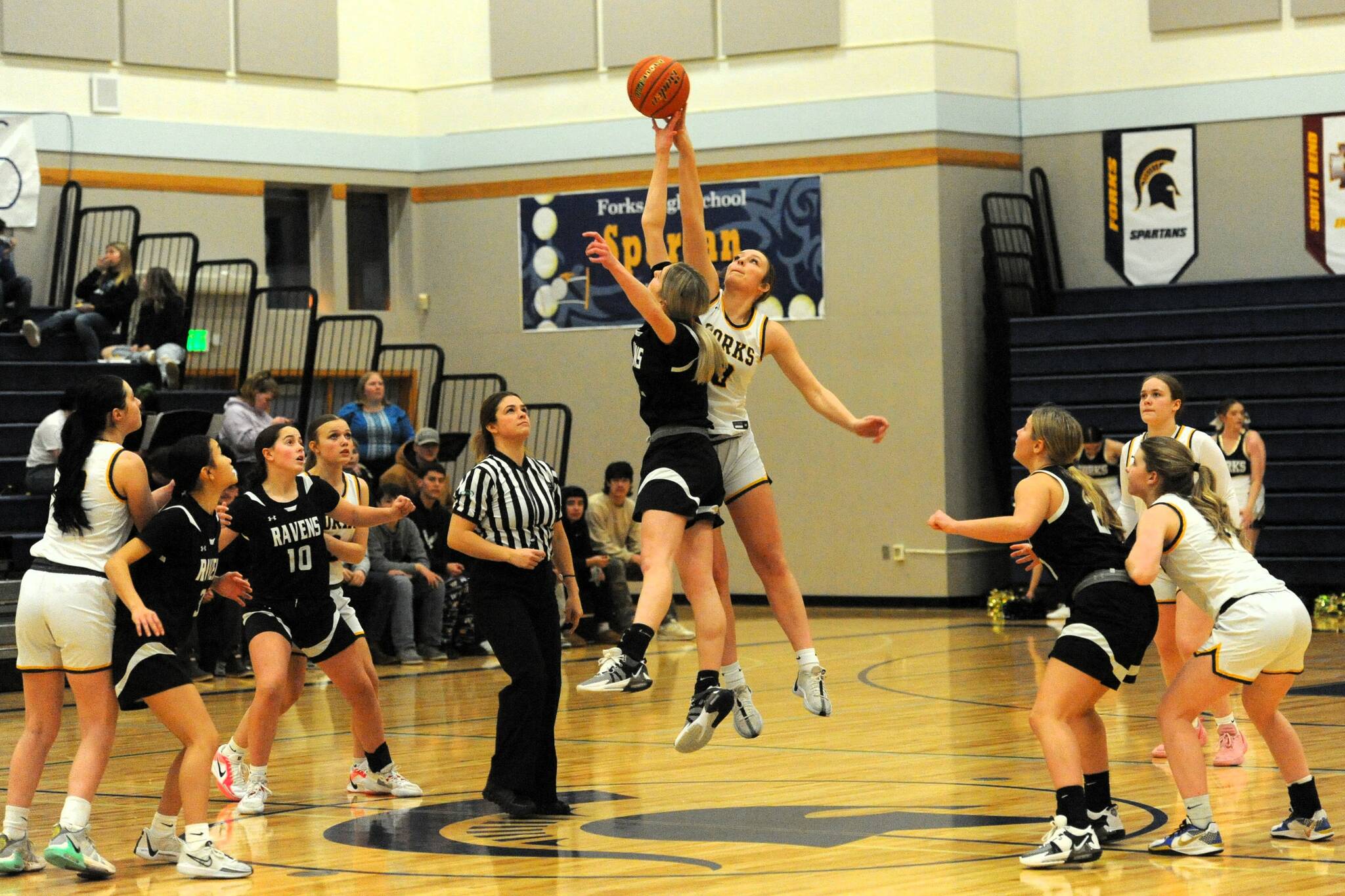 Photo by Lonnie Archibald
Forks’ Avery Dilley jumps against Raymond South Bend in the Spartan gym where the Ravens outlasted the Spartans by way of a 54 to 47 score in Pacific 2B league action. Forks had defeated the Ravens earlier in the season on the Ravens home cout but this contest was reversed as too many turnovers and fouls hampered the Spartan’s chance to win this hard-fought contest, especially in the first half of play. Other Spartans from left are Chloe Gaydeski, Karee Neel, Fynlie Peters, and Bailey Johnson.