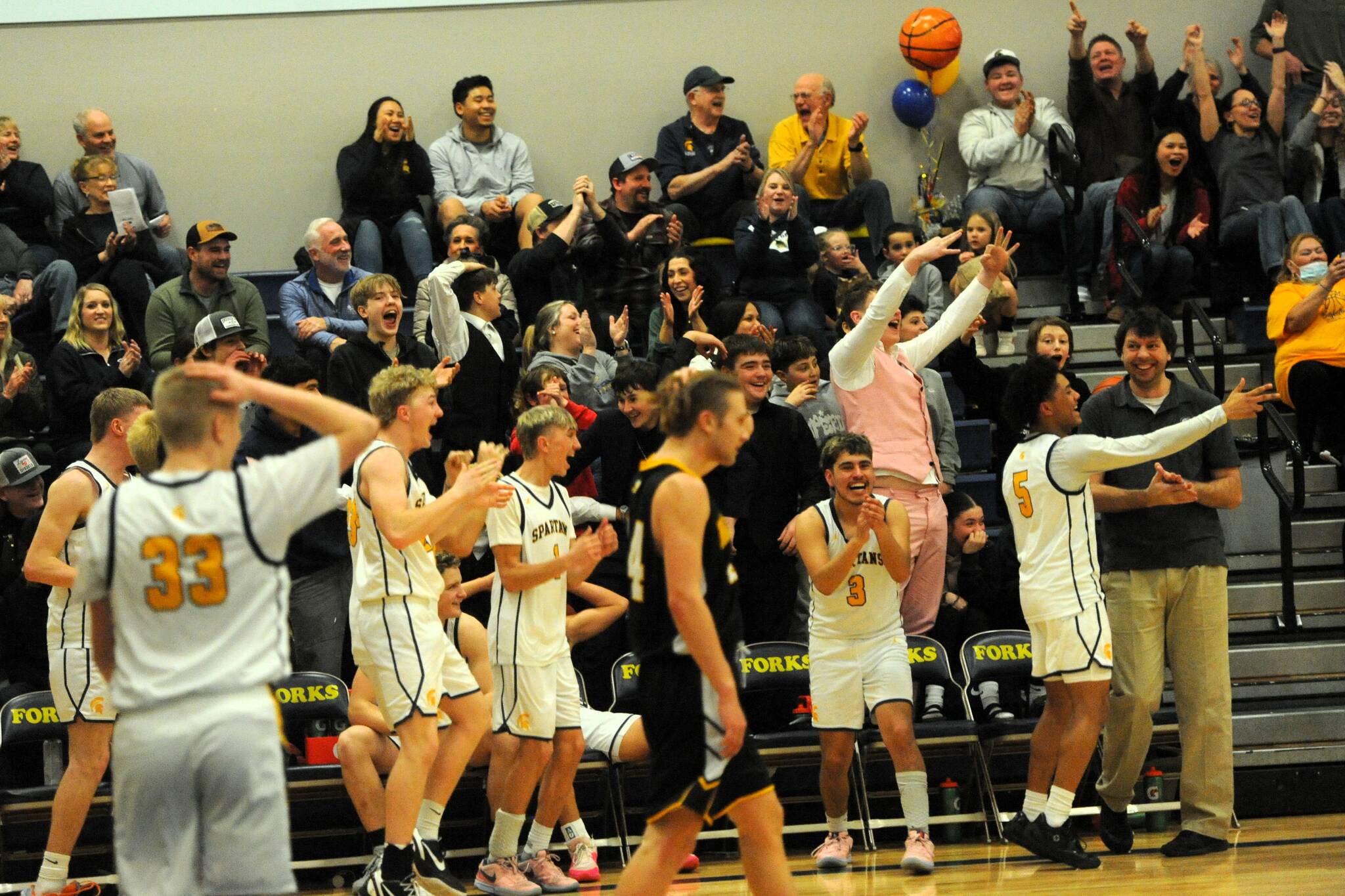 Photo Lonnie Archibald
Forks began celebrating when the final horn sounded giving the Spartans a win and the PAC 2B league championship as they defeated North Beach Friday night Jan. 31 at home. Among the group are seniors Kyle Lohrengel (1) and DeAnthony Davila (3). Spartan seniors were also honored during the game. More photos page 3.