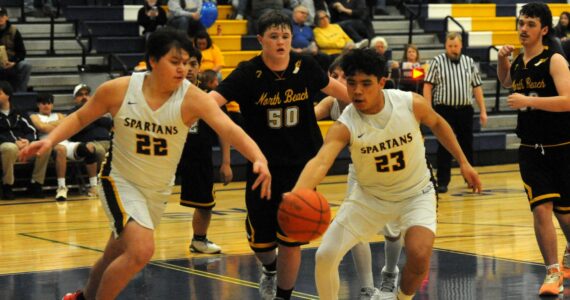 Photo by Lonnie Archibald
In Spartan JV action David Ward (22) and Kaden Ward (23) competed for ball control against North Beach who Forks defeated 68 to 30 in the Spartan Gym.