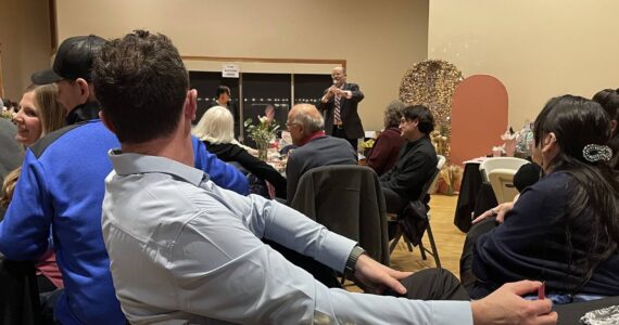 Photo Christi Baron
Rod Fleck stands at the front of the RAC Saturday evening as he served as the auctioneer to raise funds for a 3-D Mammography machine for FCH.