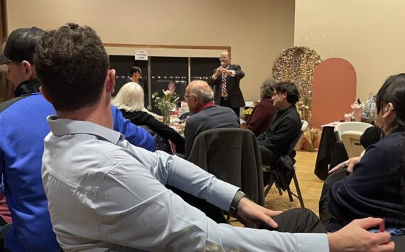 Photo Christi Baron
Rod Fleck stands at the front of the RAC Saturday evening as he served as the auctioneer to raise funds for a 3-D Mammography machine for FCH.