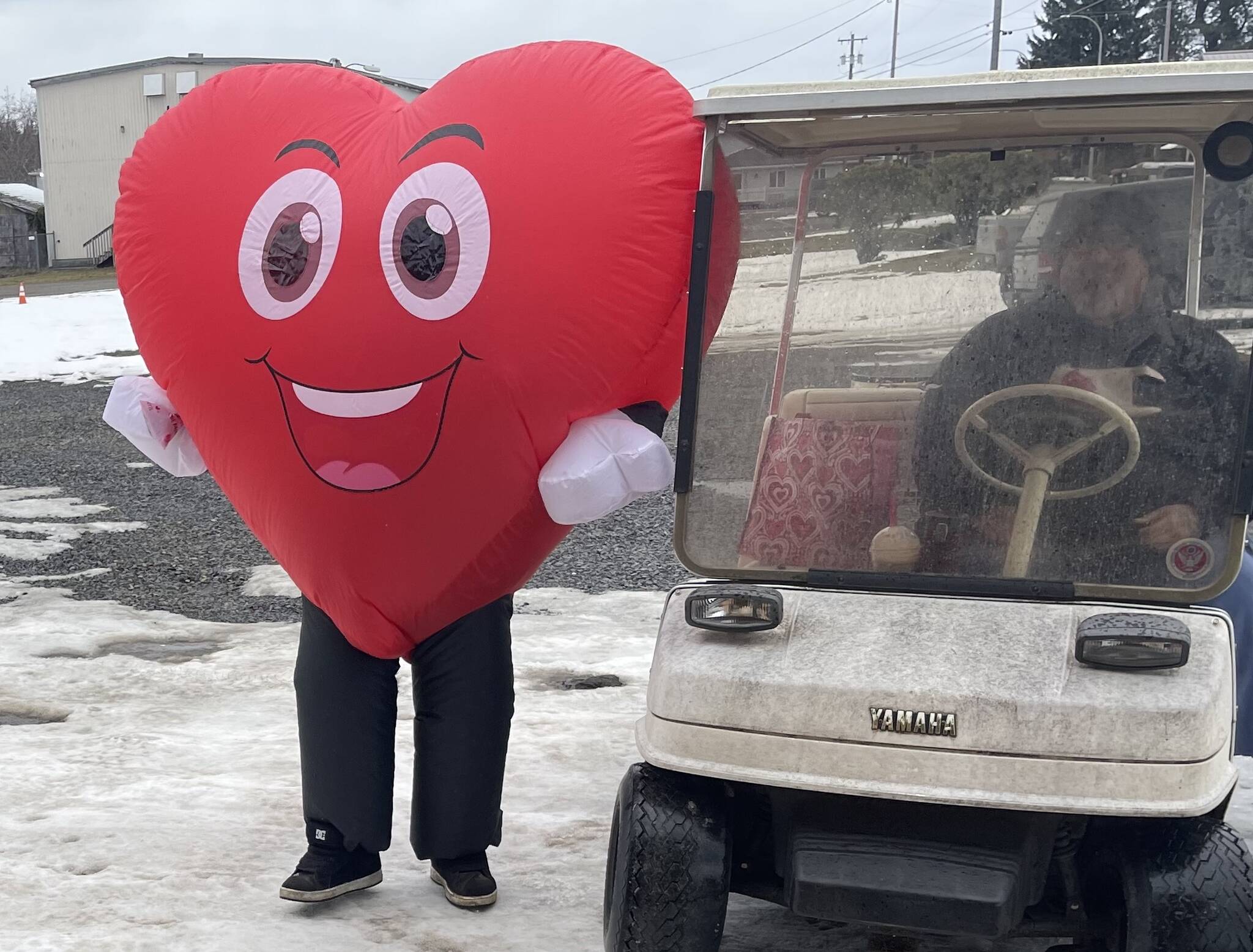 Photo Christi Baron
You never know what Jessica Hurley will do for Valentine’s Day or any other holiday for that matter. But, she was out dressed as a smiling heart and spreading happiness and handing out treats last Friday. Her husband Titus was doing the driving as she had to deflate/inflate a bit each time she got in and out of the golf cart.