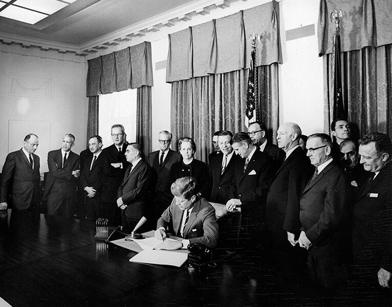 Courtesy John F. Kennedy Presidential Library and Museum
President John F. Kennedy signing legislation that allocated funds for new community mental health centers, photograph by Abbie Rowe, 1963.